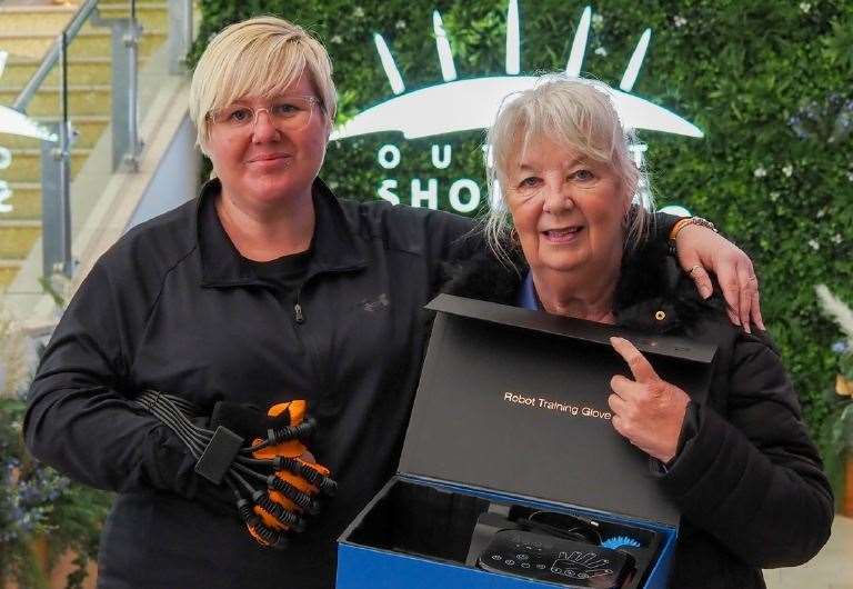 Kerry Long and her aunt Pauline Williams with the robotic hand they raised money for. Picture: Stewart Kitching