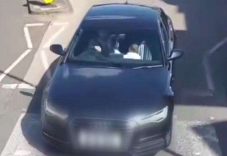Footage shows a young child in the front seat of a car not wearing a seatbelt in Herne Bay