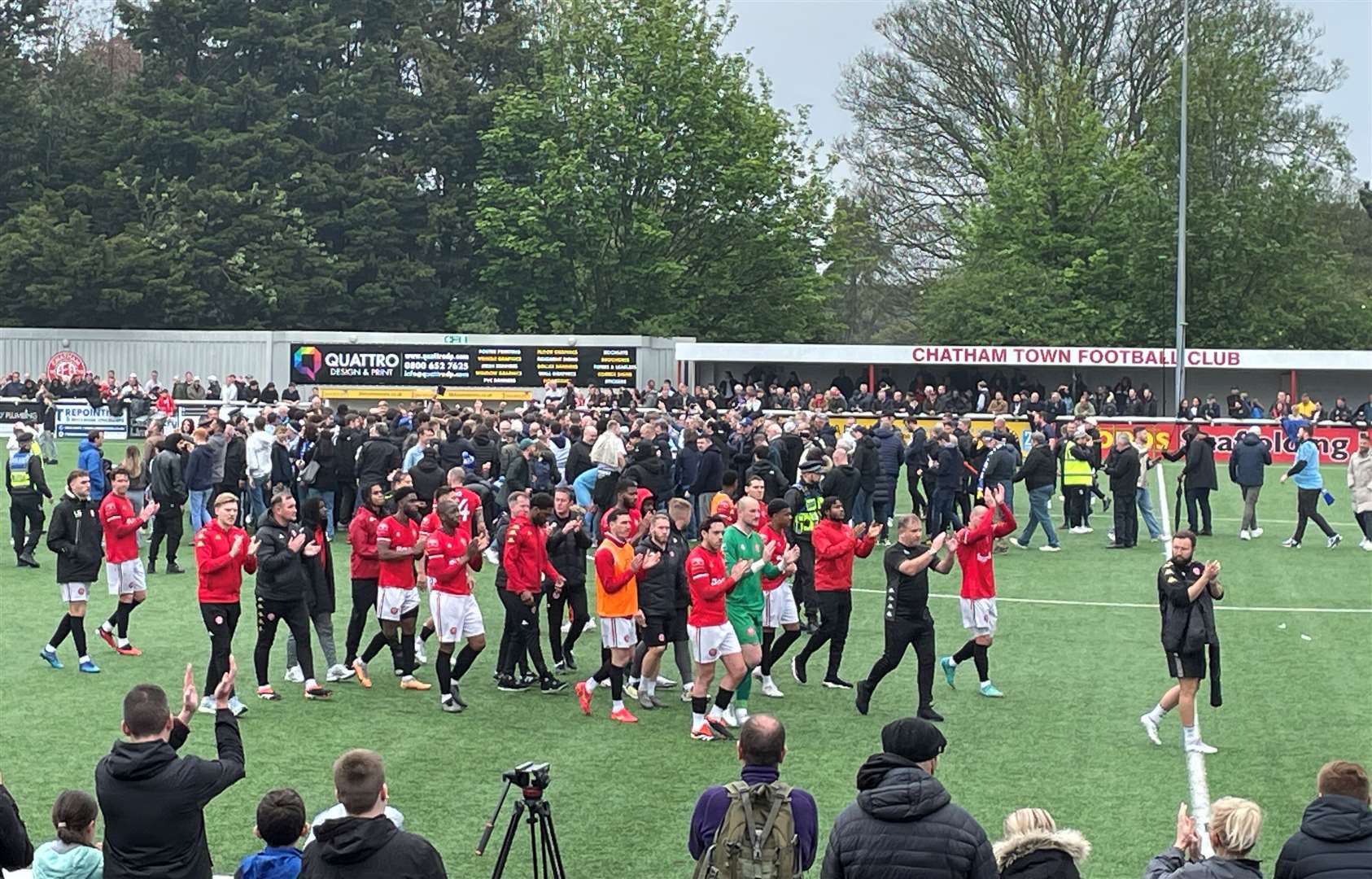 Chatham Town players and staff thank the fans as Enfield Town celebrate with their fans on the pitch