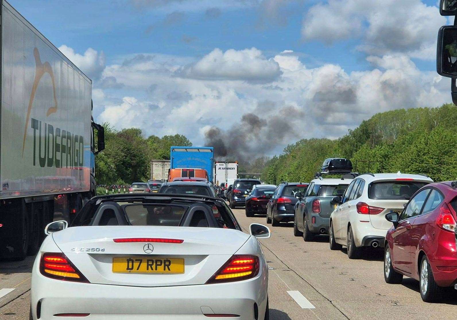 Smoke can be seen in the distance as Londonbound traffic is queued on the M20 between Ashford and Maidstone. Picture: Matt Gowen