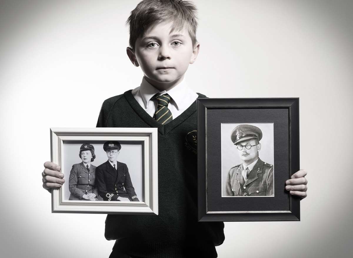 Thomas holds images of his Great Grandparents, Stanley Swain, Peggy Swaine and Sidney Herbert Randall. Picture: Scott Wishart