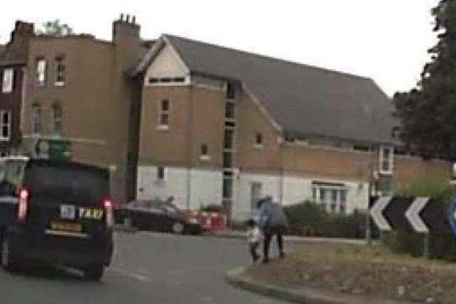 A reckless woman was seen walking across one of Canterbury's busy roundabouts with a small boy in tow