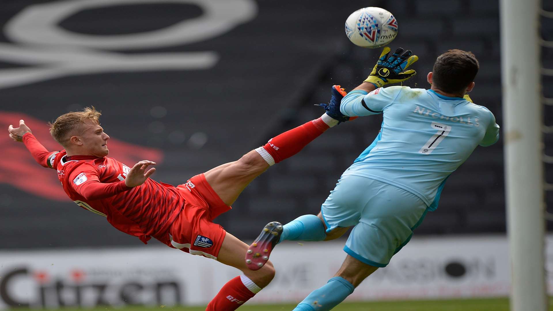 Gills' Liam Nash is fouled by MK Dons keeper Lee Nicholls. Picture: Ady Kerry