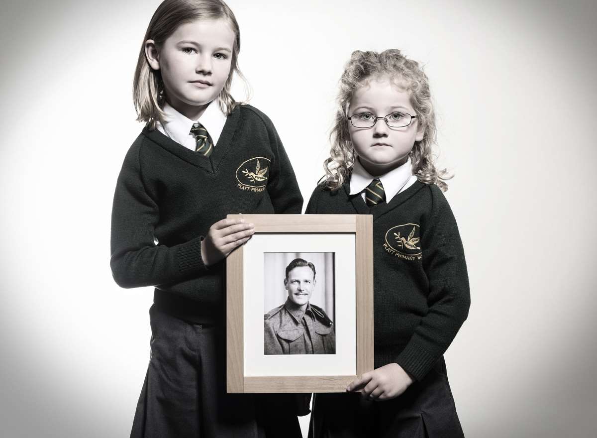 Ayla and Zoe hold photographed with a picture of their great Grandfather James Crayford. Picture: Scott Wishart
