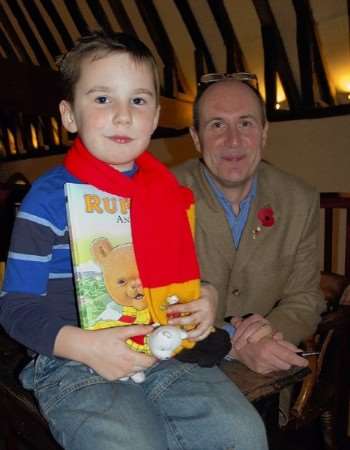 Young Rupert fan Joshua Wiseman, four, meets the new illustrator of the annual, Stuart Trotter