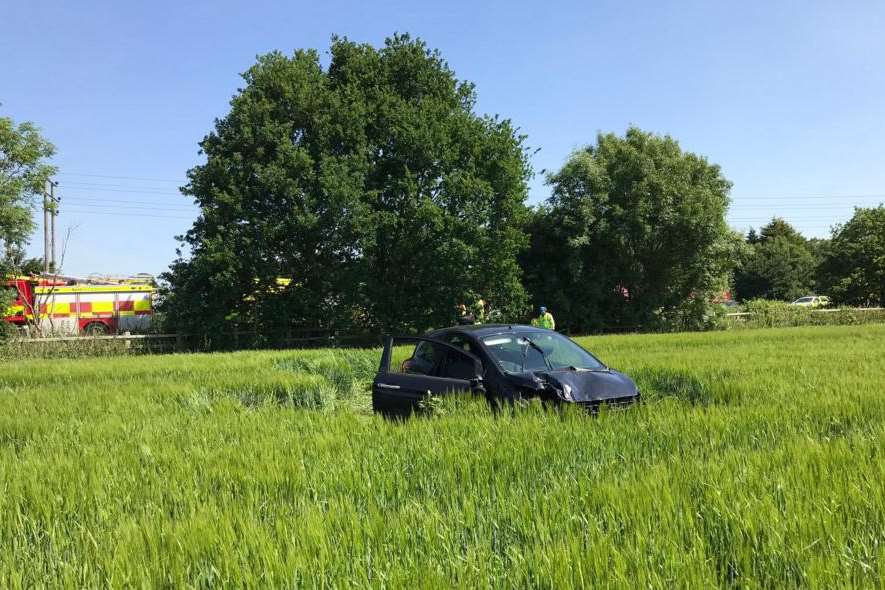 A car has ended up in a field after coming off the M2 following a crash.