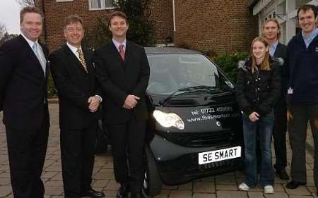 Sponsors and hospice staff with the Smart car which is top prize in a raffle. Picture: NICK JOHNSON