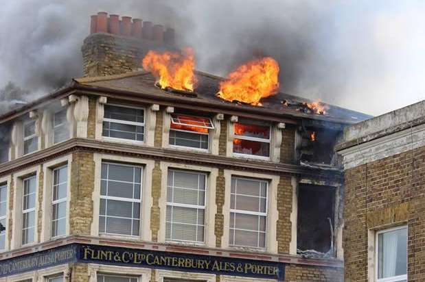 Flames erupt from the blazing building