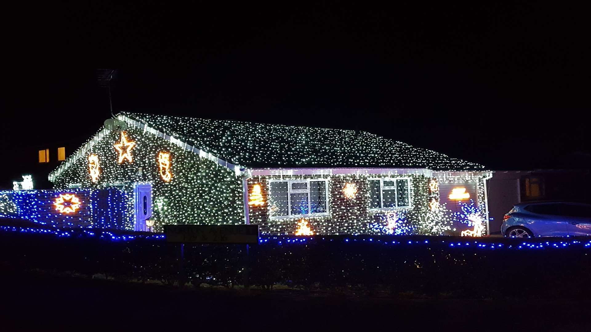 The bungalow is completely covered with Christmas lights