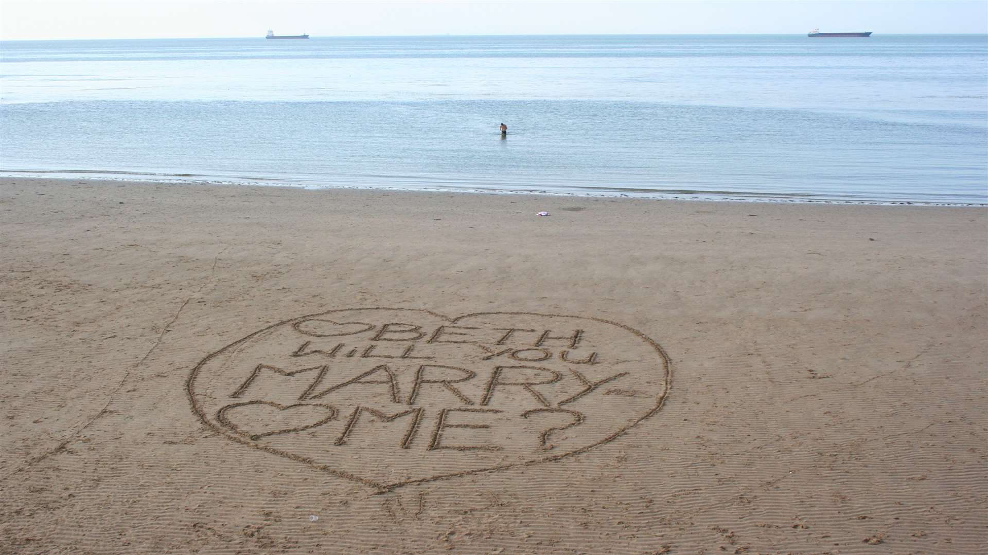 The marriage proposal written in the sand.
