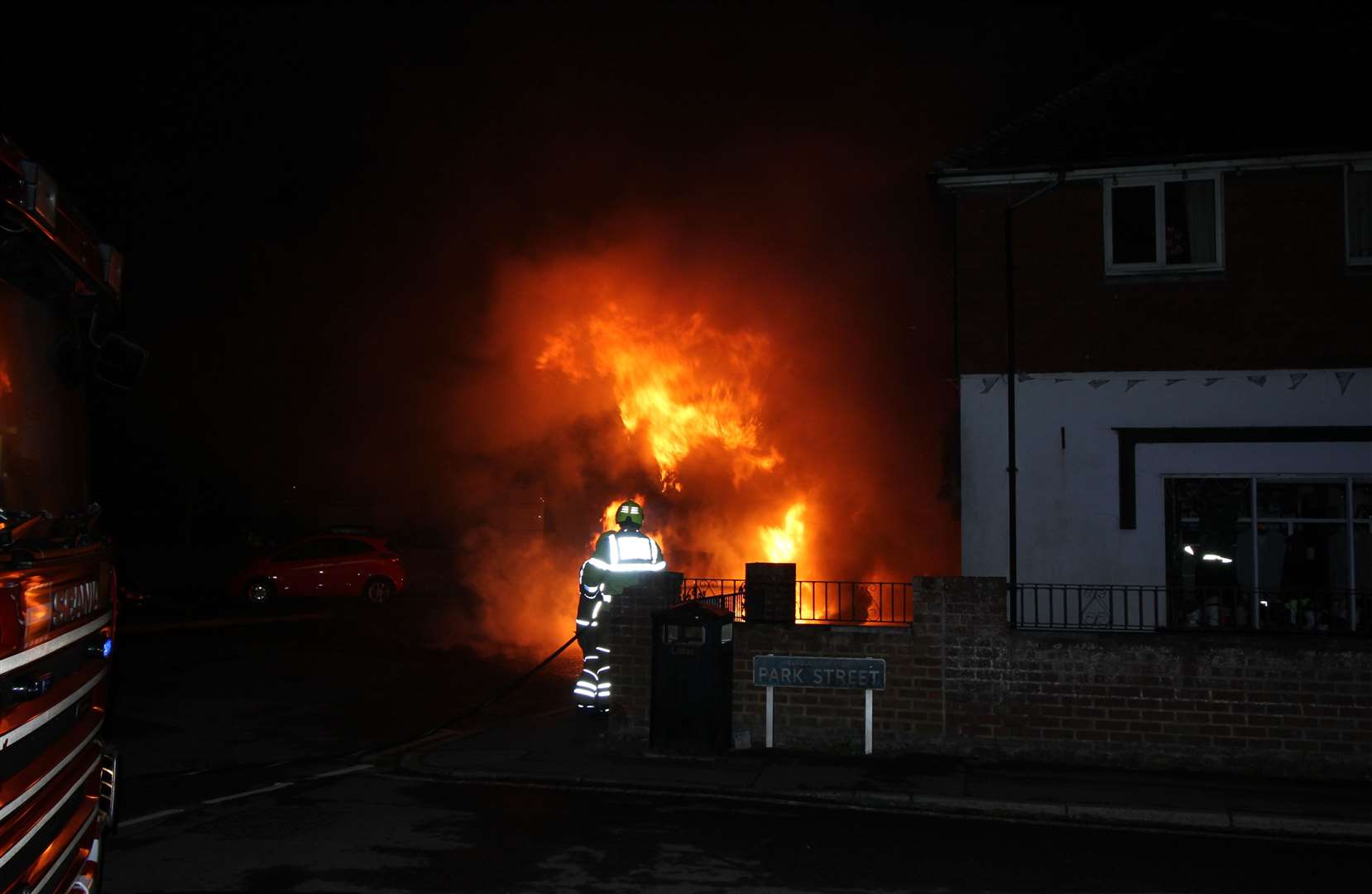 Fire crews tackling a car fire in Lydd Picture: Chris Maclean