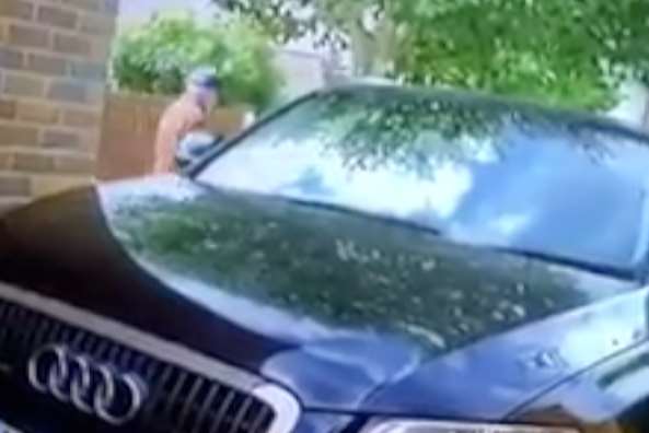 The video shows the man approaching the car from the side