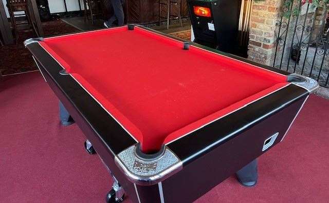 The pool table, resplendent with its bright red cloth, looked brand new and I assume it was bought with the new pub team in mind