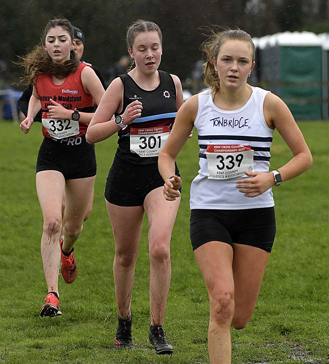 Medway and Maidstone's Ella Webb (No.332) and Carys Firth of Blackheath & Bromley Harriers (No.301) in pursuit of Tonbridge's Annabelle Hales in the under-17/20 event. Picture: Barry Goodwin (54151926)