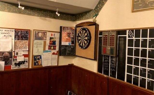 The dartboard is at the back right of the pub. This picture was taken once it was safe and the team had left for their match at the Foco Club
