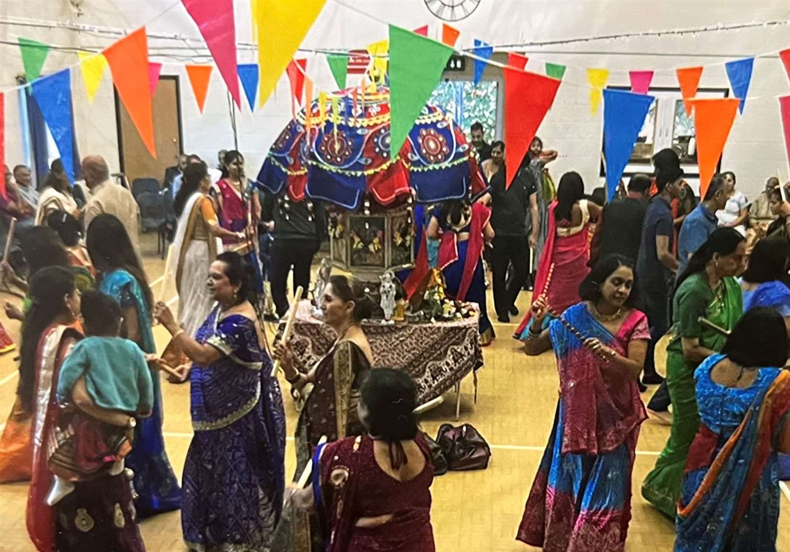 Men and women perform a special dance with dandiya sticks