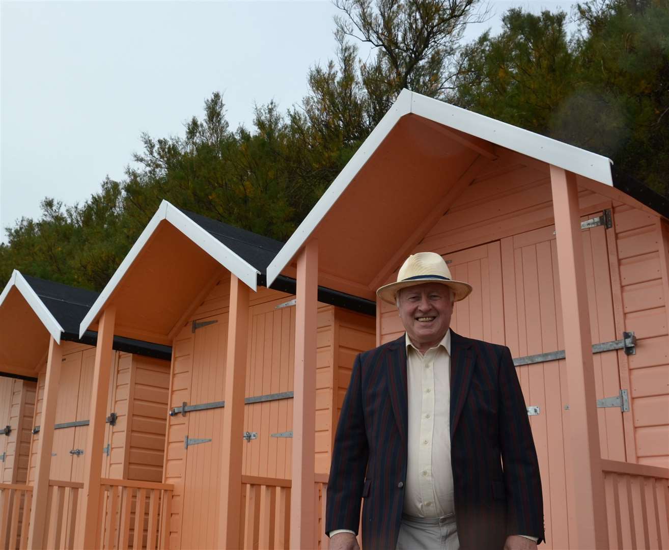 Cllr David Monk with some of the new beach huts. Picture: Folkestone council