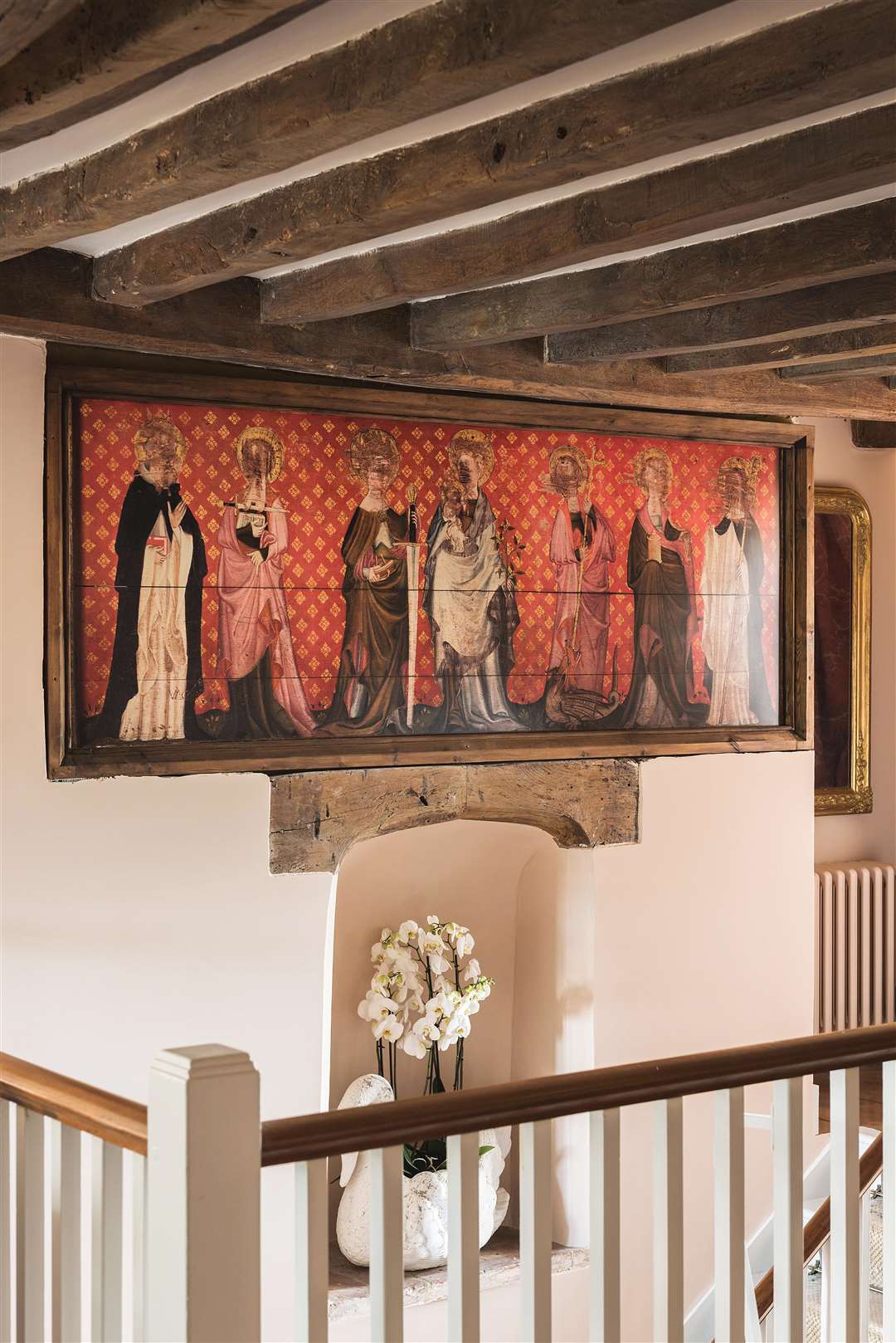 The replica of the Battel Hall retable with its scratched out faces hangs on the staircase