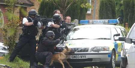Police marksmen - and dog - at the scene. Picture: MATT WALKER