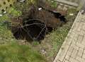 Gaping sink hole swallows front garden