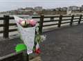 Tributes left at pier death site