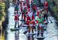 Santa paddle-board run on river 