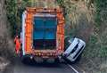 Car gets stuck after trying to pass bin lorry
