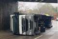 Lorry overturns after hitting railway bridge