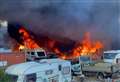 Caravan scorched in industrial blaze near woods
