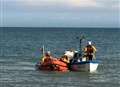 RNLI lifeboat crew rescue fishing boat skipper