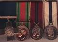 Men charged over stolen medals