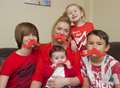 Mum goes red to put charity into black