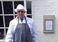 Butcher with placard protests outside restaurant
