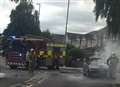 Road closed as car goes up in flames