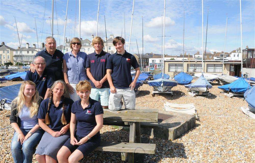 Downs Sailing Club members happy at receiving news of the grant, pictured on the beach outside their club house in Walmer