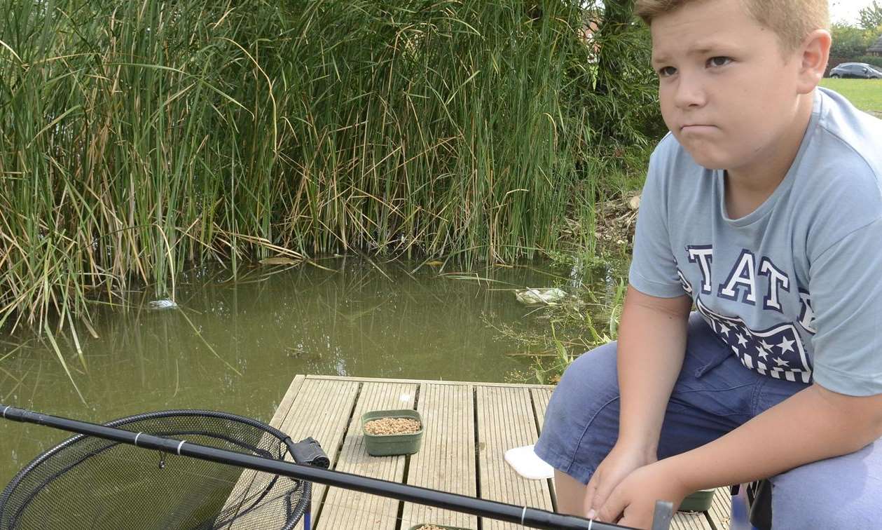 Louis Knarr, 12 contemplates the scene around the Newman Drive lake