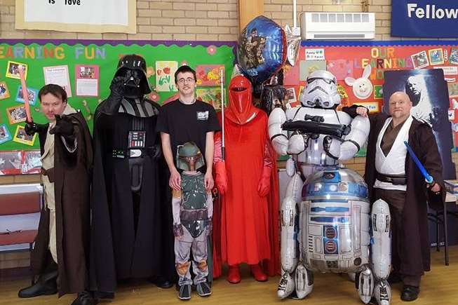 Joseph Dancer poses with dad Carl and a crew of Star Wars characters