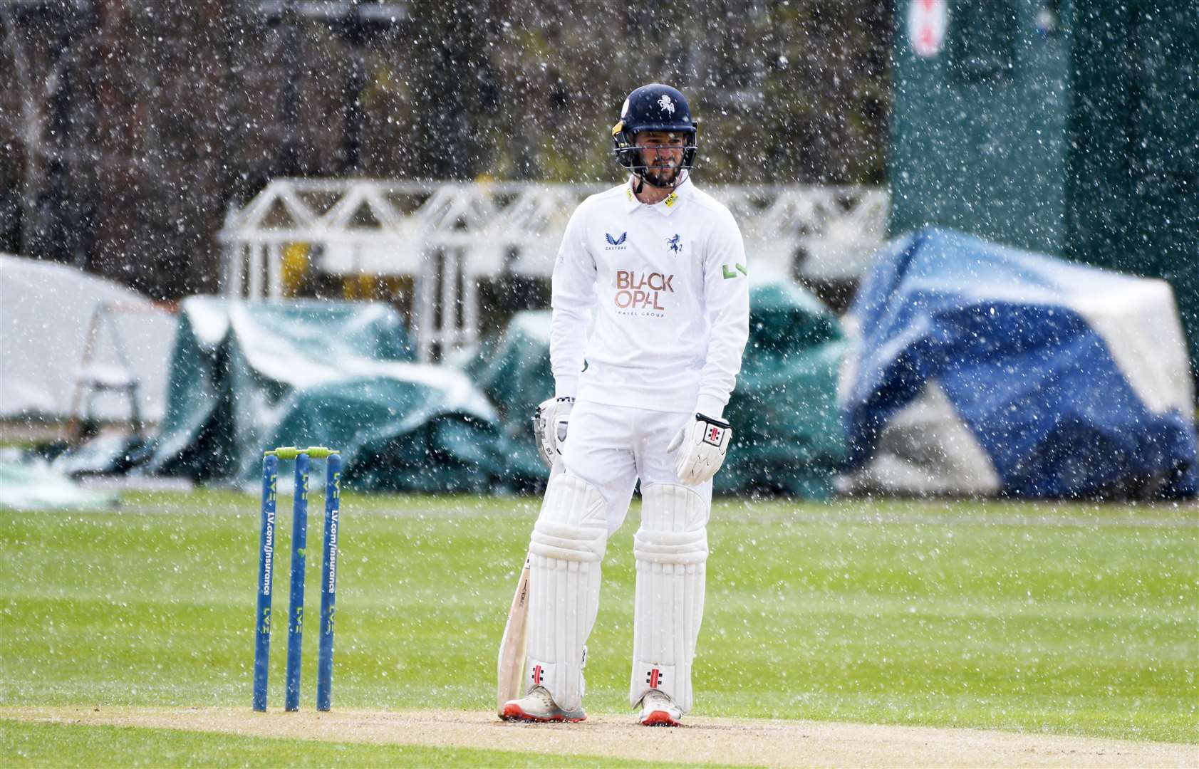 Kent's Ollie Robinson sees play stopped due to heavy snow starting to fall at Canterbury on Thursday. Picture: Barry Goodwin