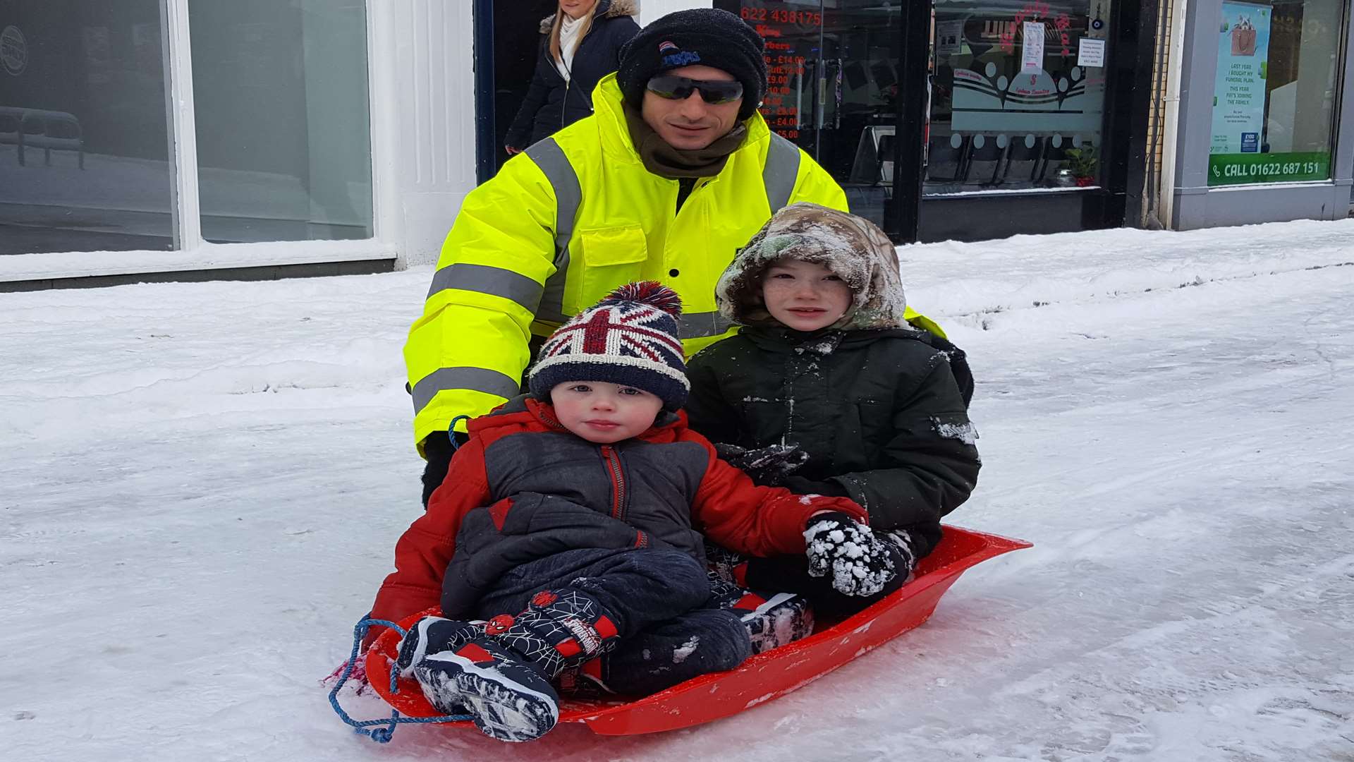 Nico, 3, Beau 6 and their dad Steve Conway out sledding on Week Street