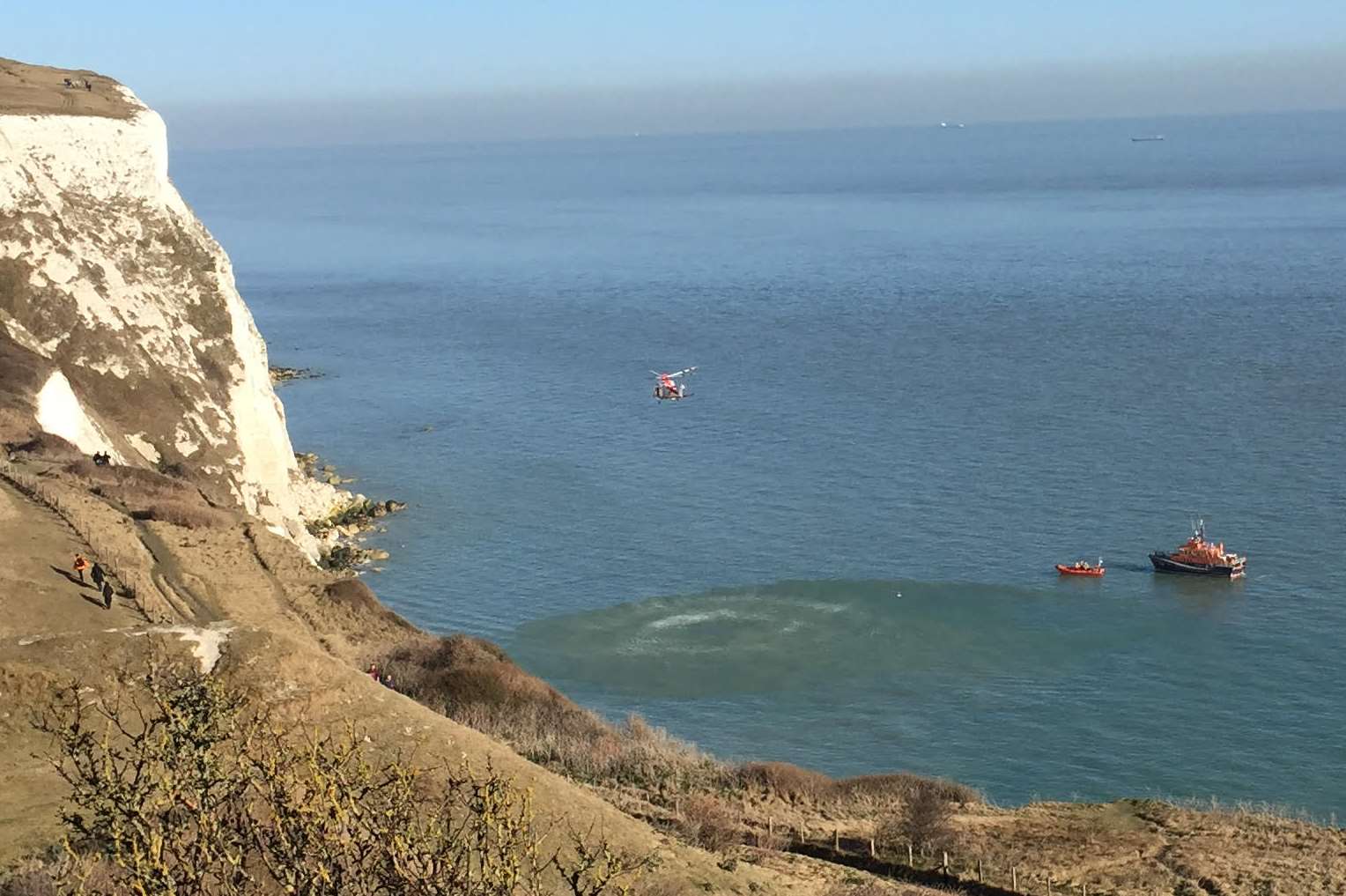 A helicopter and lifeboat vessels at the reported cliffs incident. Picture courtesy of Gracie Irvine