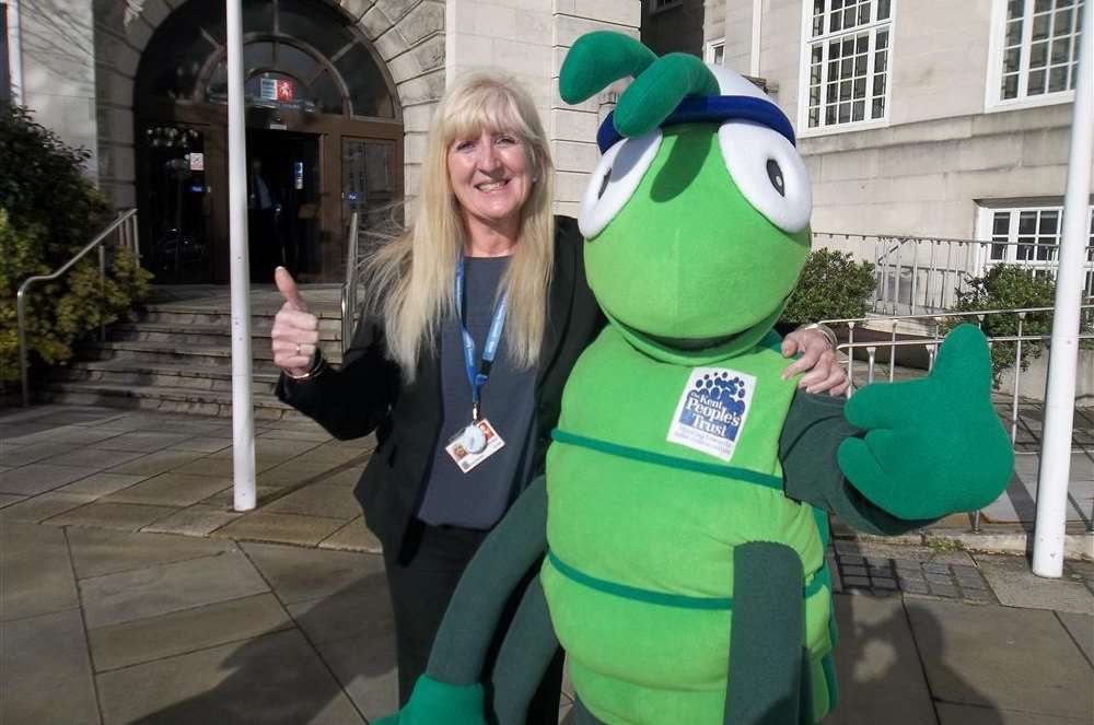 Sue Rogers, KCC Director of Education Quality and Standards, pictured with Buster Bug for the launch of Buster's Book Club. The children's literacy initiative, devised by the charity department at the KM Group.