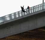 LEAP OF FAITH: The man launches himself off the bridge. Picture: BARRY CRAYFORD