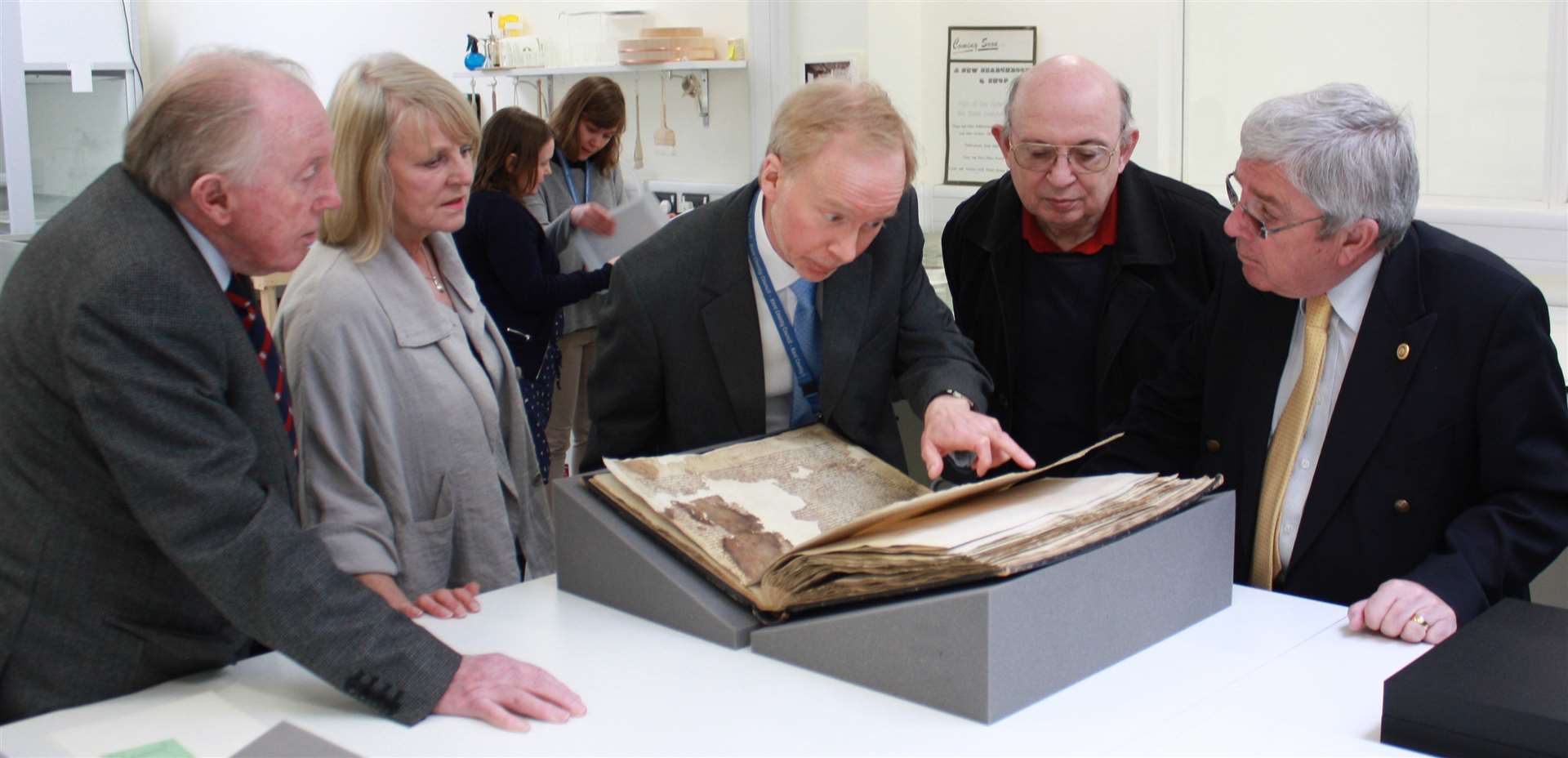 Examining the document: Cllr John Bragg, Cllr Pip Russell, Dr Mark Bateson, museum archivist Ray Harlow and Mayor of Sandwich, Cllr Paul Graeme