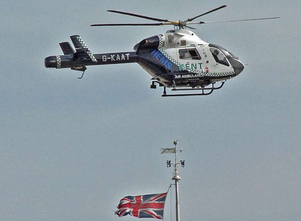 The air ambulance hovering above the clock tower in Dover
