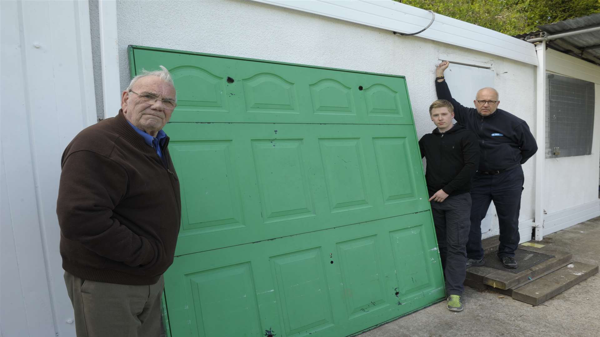 Colin Gardener (Chairman), Mark Ruddy and Richard Cross with the garage door the vandals removed so they could get in.