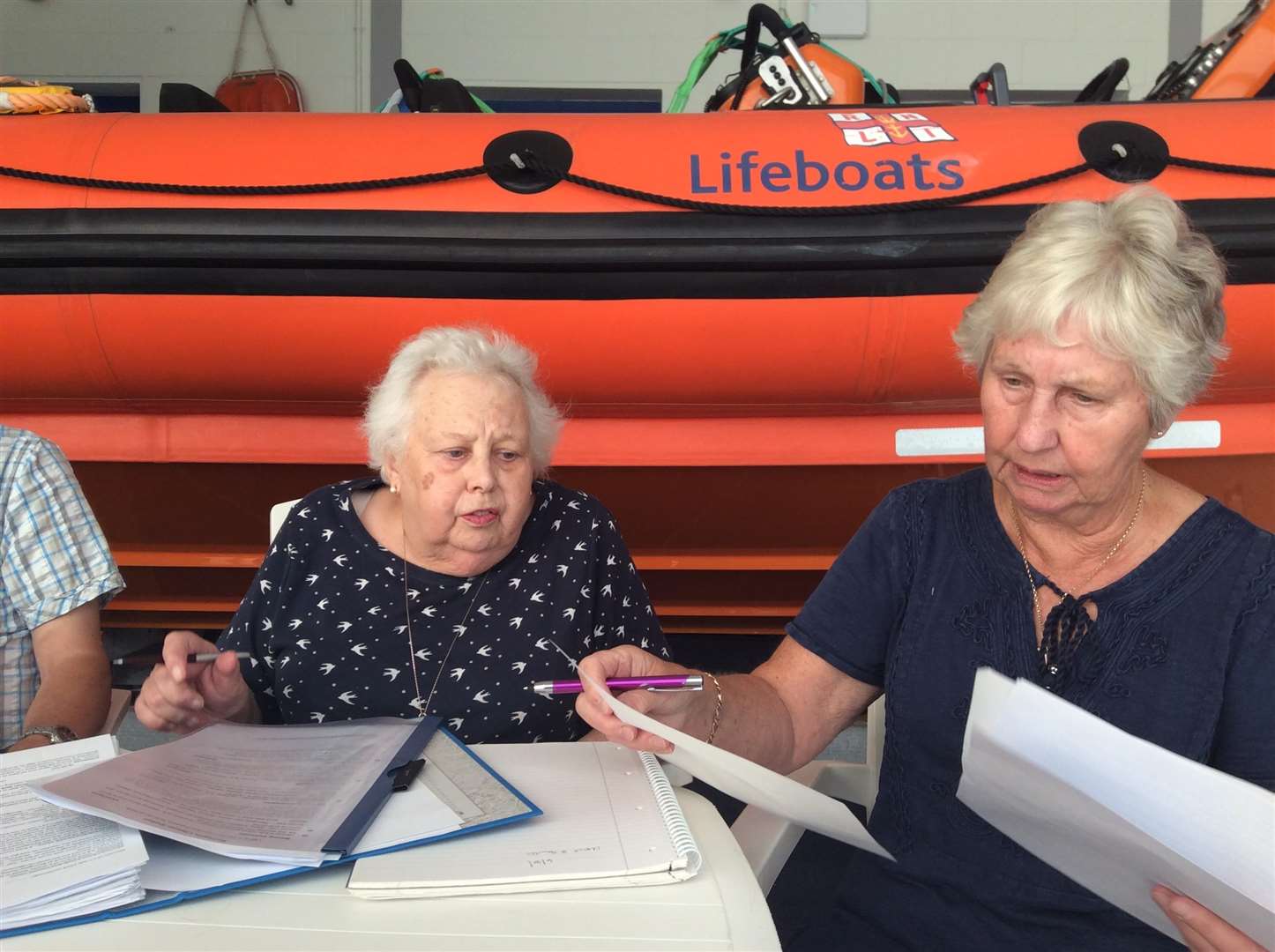 Elsie, left, at her last meeting passing on her knowledge to the new secretary, Jean Picture: RNLI/ Karen Cox (3593527)