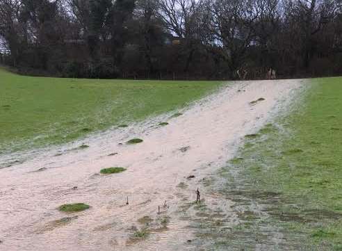 A stream of water has collected in Coombe Wood Riding School's field in Hawkinge. Picture: Tim Fuller