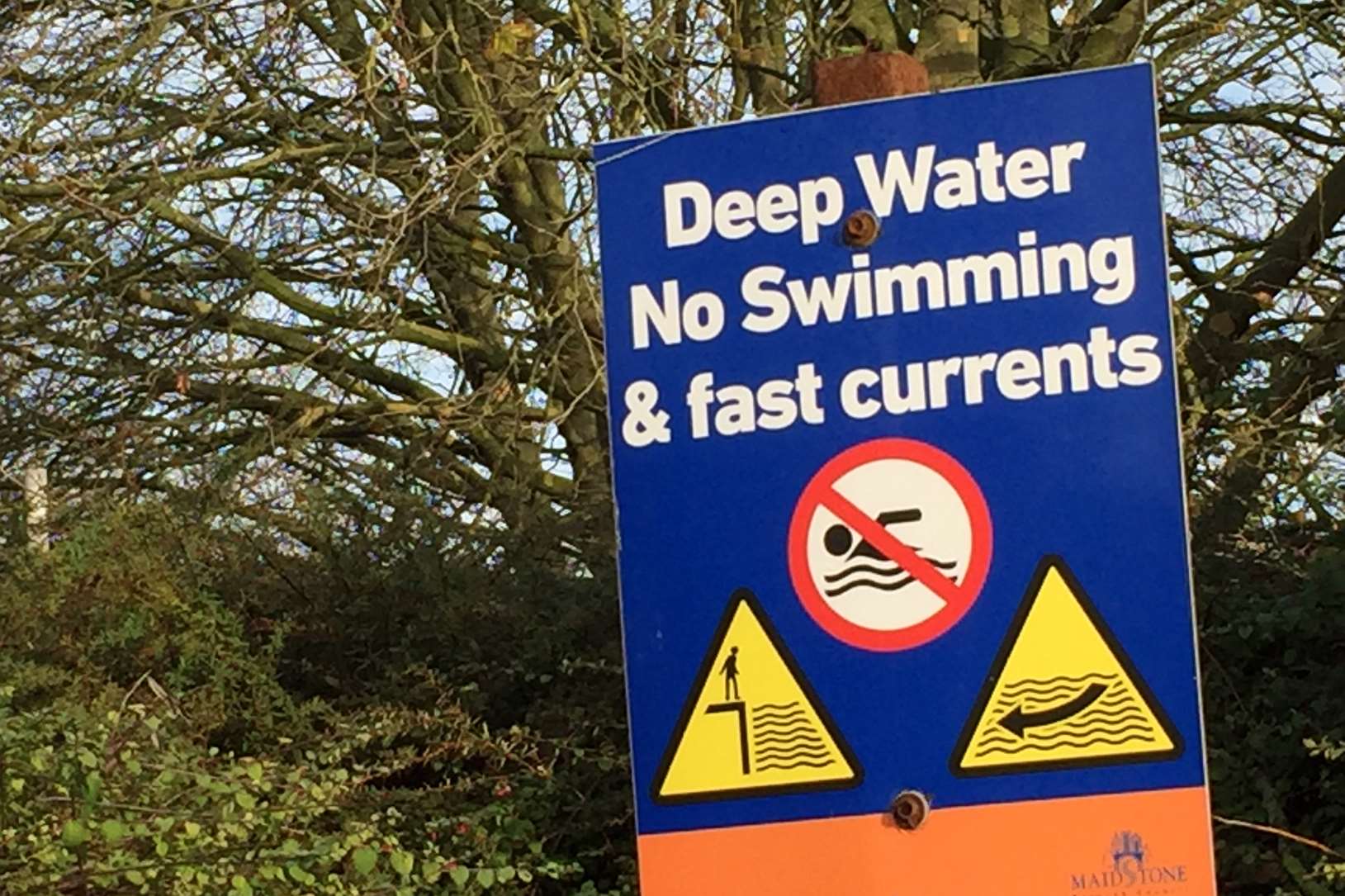 A sign warning of the dangers of entering the River Medway.