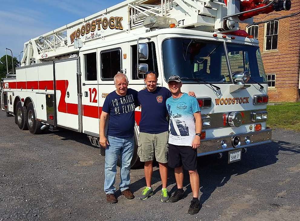 Bill Best, firefighter Adam Burner of Woodstock Fire Department in Virginia, and Bill’s son, Richard Best, with the fire truck
