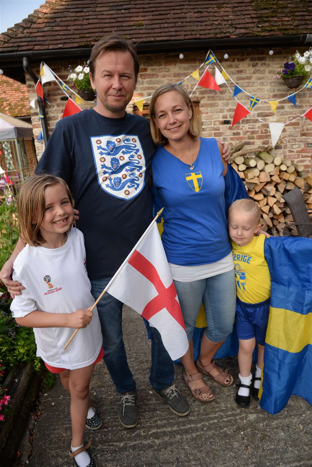 Divided loyalties over the World Cup, Mike Abbott and his Swedish partner Anna Svensson and their children Alice, seven and Ellen, four at the Yew Tree pub, Westbere. Picture: Chris Davey... (2910598)